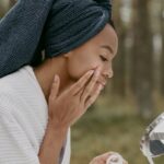 woman putting acne medication on face